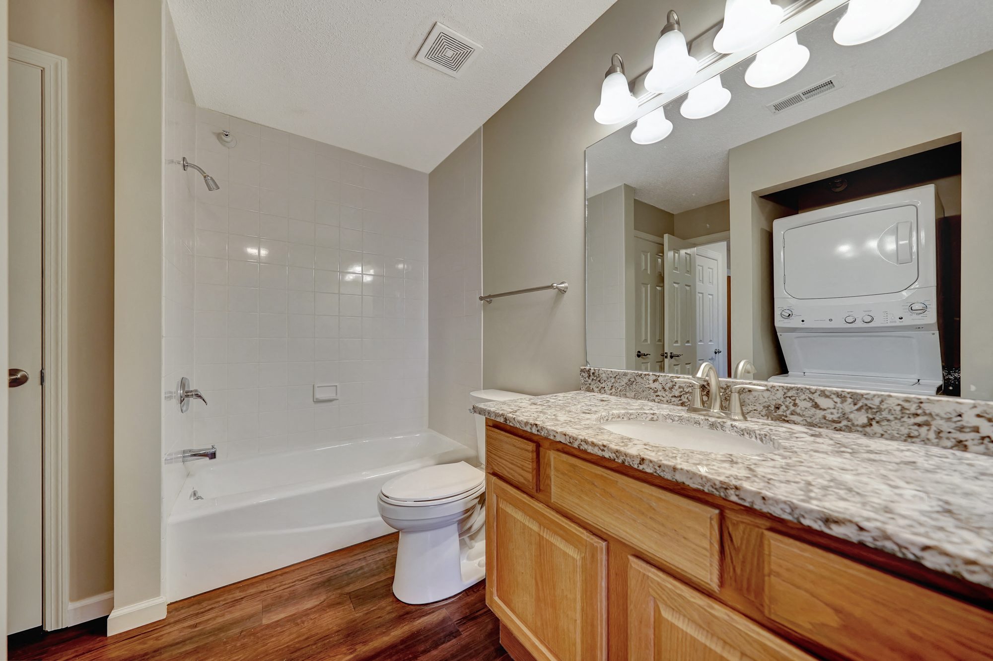 a bathroom with a shower toilet and sink and a mirror